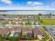 A marked aerial view highlights a tan two-story home featuring a screened patio and a fenced yard with nearby lake views at 211 Lazio Cir, Debary, FL 32713