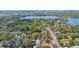 Overhead view captures the serene homes near a lake, with mature trees and a pool enhancing the neighborhood's charm at 250 Cortland Ave, Winter Park, FL 32789