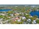 Aerial view captures a residential area near a lake, displaying a blend of houses and trees along roads at 250 Cortland Ave, Winter Park, FL 32789