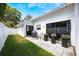 Relaxing outdoor patio area with a grill, seating, decorative plants, and sliding doors leading indoors at 250 Cortland Ave, Winter Park, FL 32789