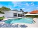 Sparkling backyard pool with an attached spa, surrounded by lush greenery and a view of the home's exterior at 250 Cortland Ave, Winter Park, FL 32789