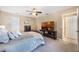 Cozy bedroom with ceiling fan, comfortable bed, soft carpet, and a television on a wooden stand at 250 Cortland Ave, Winter Park, FL 32789
