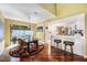 Dining area with hardwood floors, modern chandelier, access to kitchen, and sliding glass doors to the outdoor space at 250 Cortland Ave, Winter Park, FL 32789