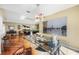 Open concept dining room featuring a glass table, contemporary chandelier, and a view into the game room at 250 Cortland Ave, Winter Park, FL 32789