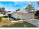 Inviting single-story home featuring a two-car garage, well-manicured lawn, and quaint front entrance under a sunny sky at 250 Cortland Ave, Winter Park, FL 32789