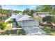 Charming single-story home with a well-manicured lawn, lush landscaping, and a spacious two-car garage at 250 Cortland Ave, Winter Park, FL 32789