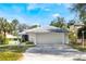 Single-story home with a two-car garage, landscaped yard, and a purple front door at 250 Cortland Ave, Winter Park, FL 32789