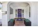 Charming home entrance showcasing an arched entryway, a vibrant purple door, and decorative accents at 250 Cortland Ave, Winter Park, FL 32789