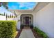 Welcoming entryway featuring a vibrant purple door, manicured hedges, and a charming decorative wreath at 250 Cortland Ave, Winter Park, FL 32789
