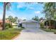 Charming single-story home showcasing a well-manicured lawn, large garage, and vibrant landscaping at 250 Cortland Ave, Winter Park, FL 32789