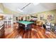 Spacious game room with a pool table, drum set, hardwood floors, and skylights, perfect for entertaining and leisure at 250 Cortland Ave, Winter Park, FL 32789