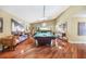 Spacious game room boasts a pool table, hardwood floors, a skylight, and tasteful decor at 250 Cortland Ave, Winter Park, FL 32789