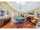 Game room featuring a billiard table, wood floors, skylights, and open access to the kitchen at 250 Cortland Ave, Winter Park, FL 32789