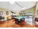 Spacious game room with a pool table, hardwood floors, high ceilings, and access to the covered patio at 250 Cortland Ave, Winter Park, FL 32789