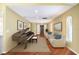 Light filled foyer/hallway, neutral decor, light colored walls, wood floor, and grand piano at 250 Cortland Ave, Winter Park, FL 32789