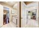 Hallway view of bathroom and kitchen featuring tile floors, white cabinets and stainless steel appliances at 250 Cortland Ave, Winter Park, FL 32789