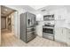 Bright kitchen with stainless steel appliances, white cabinetry, and easy access to an adjacent doorway at 250 Cortland Ave, Winter Park, FL 32789