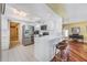 Modern kitchen with white cabinets, stainless steel appliances, breakfast bar, and tiled flooring for a clean and efficient space at 250 Cortland Ave, Winter Park, FL 32789