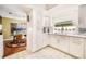 Bright kitchen boasting white cabinets, a window over the sink, and a view of the dining area at 250 Cortland Ave, Winter Park, FL 32789