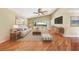 Bright living room features vaulted ceiling, hardwood floors, sliding glass doors to a pool, and neutral decor at 250 Cortland Ave, Winter Park, FL 32789