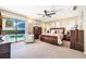 Spacious main bedroom featuring carpet floors, modern furniture, ceiling fan, and access to the pool at 250 Cortland Ave, Winter Park, FL 32789