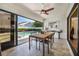 Covered outdoor patio offers a dining area with views of the pool, merging indoor and outdoor living at 250 Cortland Ave, Winter Park, FL 32789