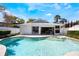 The private backyard features a sparkling pool and spa with a covered patio and lush landscaping at 250 Cortland Ave, Winter Park, FL 32789