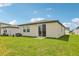 Lush backyard with a sliding glass door and well-maintained green grass at 2507 Linda Knoll Ln, Bartow, FL 33830