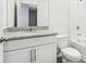 Bathroom with granite countertop vanity, ceramic tile and white cabinets at 2507 Linda Knoll Ln, Bartow, FL 33830