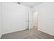 Clean, carpeted bedroom with neutral walls, a closet, and a window, perfect for a minimalist design at 2507 Linda Knoll Ln, Bartow, FL 33830