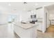 Bright open-concept kitchen features an island, granite countertops, white cabinetry and stainless steel appliances at 2507 Linda Knoll Ln, Bartow, FL 33830