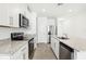 Galley kitchen featuring stainless steel appliances, granite countertops, and white cabinets at 2507 Linda Knoll Ln, Bartow, FL 33830