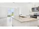 Bright kitchen with granite countertops, stainless steel sink, and backyard access at 2507 Linda Knoll Ln, Bartow, FL 33830