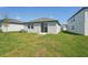 Spacious backyard featuring a well-maintained lawn and a modern sliding glass door at 2514 Linda Knoll Ln, Bartow, FL 33830