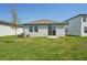 Spacious backyard featuring a well-maintained lawn and a modern sliding glass door at 2514 Linda Knoll Ln, Bartow, FL 33830
