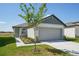 Charming single-Gathering home featuring a two-car garage, landscaped front yard, and neutral color palette at 2514 Linda Knoll Ln, Bartow, FL 33830