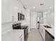 Well-lit kitchen with stainless steel appliances, white cabinets, and quartz countertops at 2514 Linda Knoll Ln, Bartow, FL 33830