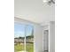 Bright living room featuring a sliding glass door with scenic views and interior door at 2514 Linda Knoll Ln, Bartow, FL 33830