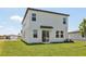 Rear view of home with sliding glass door and expansive backyard at 2515 Linda Knoll Ln, Bartow, FL 33830
