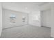 Bright loft area featuring gray carpet, white walls, and natural light from the window at 2515 Linda Knoll Ln, Bartow, FL 33830
