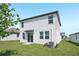 Green backyard with a sliding glass door and a view of the home's exterior siding at 2518 Linda Knoll Ln, Bartow, FL 33830