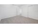 A bright, carpeted bedroom with an open door and closet at 2518 Linda Knoll Ln, Bartow, FL 33830