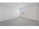 Bright carpeted bedroom features a window and white walls at 2518 Linda Knoll Ln, Bartow, FL 33830