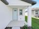 Inviting front porch featuring a light blue door and white pillars at 2518 Linda Knoll Ln, Bartow, FL 33830