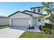 Charming home with a two-car garage, manicured lawn, and a light blue front door at 2518 Linda Knoll Ln, Bartow, FL 33830