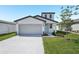 Charming home with a two-car garage, manicured lawn, and a light blue front door at 2518 Linda Knoll Ln, Bartow, FL 33830