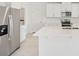 Open kitchen featuring stainless steel appliances and a large white quartz island at 2518 Linda Knoll Ln, Bartow, FL 33830