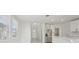 Well-lit kitchen with white cabinets, stainless steel appliances, and a view of the backyard at 2518 Linda Knoll Ln, Bartow, FL 33830