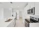 Open kitchen with a large island, stainless steel appliances, and white cabinetry at 2518 Linda Knoll Ln, Bartow, FL 33830