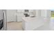 Open kitchen with a large white quartz island and stainless steel appliances at 2518 Linda Knoll Ln, Bartow, FL 33830